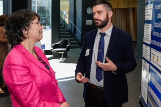 Sean Regnier, College of Medicine postdoctoral fellow, shares his research NIH Director Monica Bertagnolli. His work is focused on understanding why patients with disabilities smoke to inform effective and sustainable treatments.