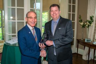 Jason Unrine accepting the award from President Capilouto.