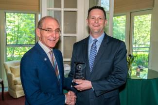 Phillip Gribble accepting the award from President Capilouto.