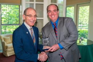W. Hunter Stamps accepting the award from President Capilouto.