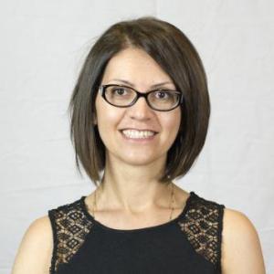 Radmila Choate, a white women with chin length dark brown hair, wearing black rim glasses