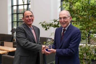 Zach Agioutantis accepting an award from UK President Eli Capilouto
