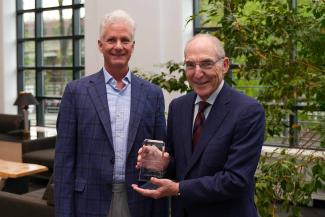 Ty Borders accepting the University Research Professor award from UK President Eli Capilouto.