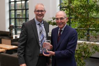 David J. Feola accepting the University Research Professor award from UK President Eli Capilouto.