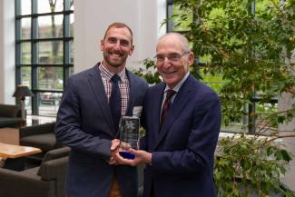 Nicholas Heebner accepting the University Research Professor award from UK President Eli Capilouto.