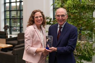 Krystle A. Lang Kuhs accepting the University Research Professor award from UK President Eli Capilouto.