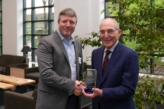 Chris Richards accepting the University Research Professor award from UK President Eli Capilouto.