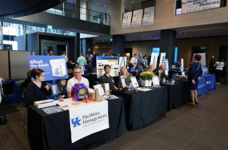 display tables set up at the 2025 Sustainability Showcase, with UK facilities Management in the foreground