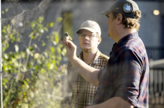 Will Gibson, left, watching bird banding with Darin “DJ” McNeil.