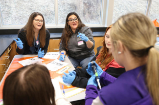 ESCAPE research team members Kerry Hamilton, Ph.D., Arizona State University, and Sahar Alameh, Ph.D., UK College of Education, work with Buckhorn School students testing a water sample from Squabble Creek