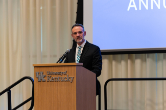 Chad Risko speaking at a podium