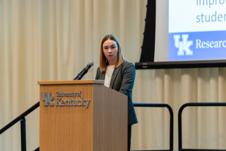 Hope Harvey speaks behind a University of Kentucky podium