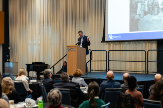 Daniel Vivian speaks on stage in front of CURATE 2026 attendees