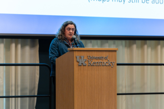 Ruth Bryan speaks behind a University of Kentucky podium