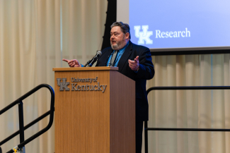 Michael Murray speaks behind a University of Kentucky podium