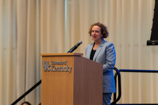 Ilhem Messaoudi speaks behind a University of Kentucky podium