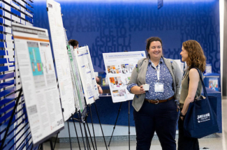 conference attendees view research posters 