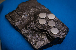 lithium-ion batteries sitting on a block of coal