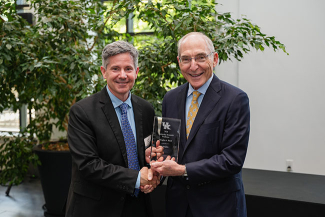 Douglas A. Boyd accepting an award from Eli Capilouto.