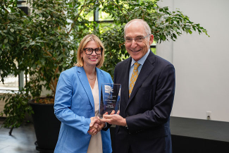 Greg A. Gerhardt accepting an award from Eli Capilouto.