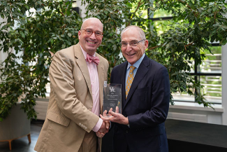 Patrick Lee Lucas accepting an award from Eli Capilouto.
