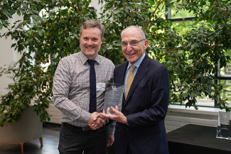 Nathaniel Stapleton accepting an award from Eli Capilouto.