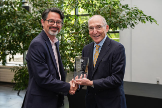 Joseph K. Young accepting and award from Eli Capilouto.