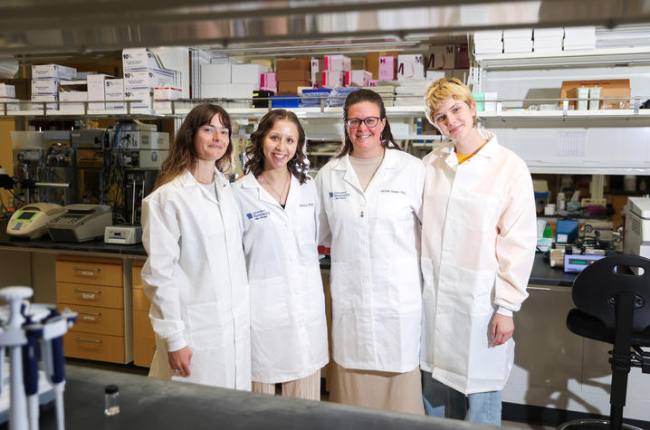 Caroline Geisler and her research team standing in a lab