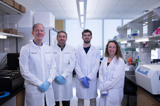 Ebbert lab researchers standing in a lab