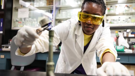 lab worker lighting Bunson burner