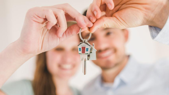couple holding keys to a home
