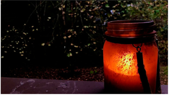 A dirty candle jar outdoors