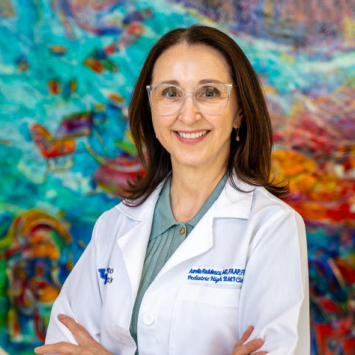 Aurelia Radulescu stands against a colorful wall
